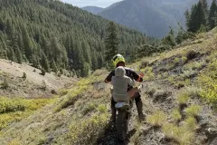 Gwinn lifting Wayment down the hill on his bike